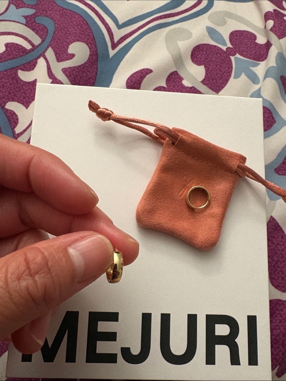 Mejuri 10k gold Bold Huggie Hoops with original packaging.